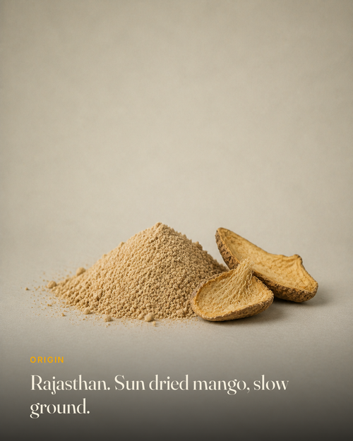 The ingredient behind GetPured Amchur Powder, photographed on a warm studio backdrop with a caption naming its origin and how it is made